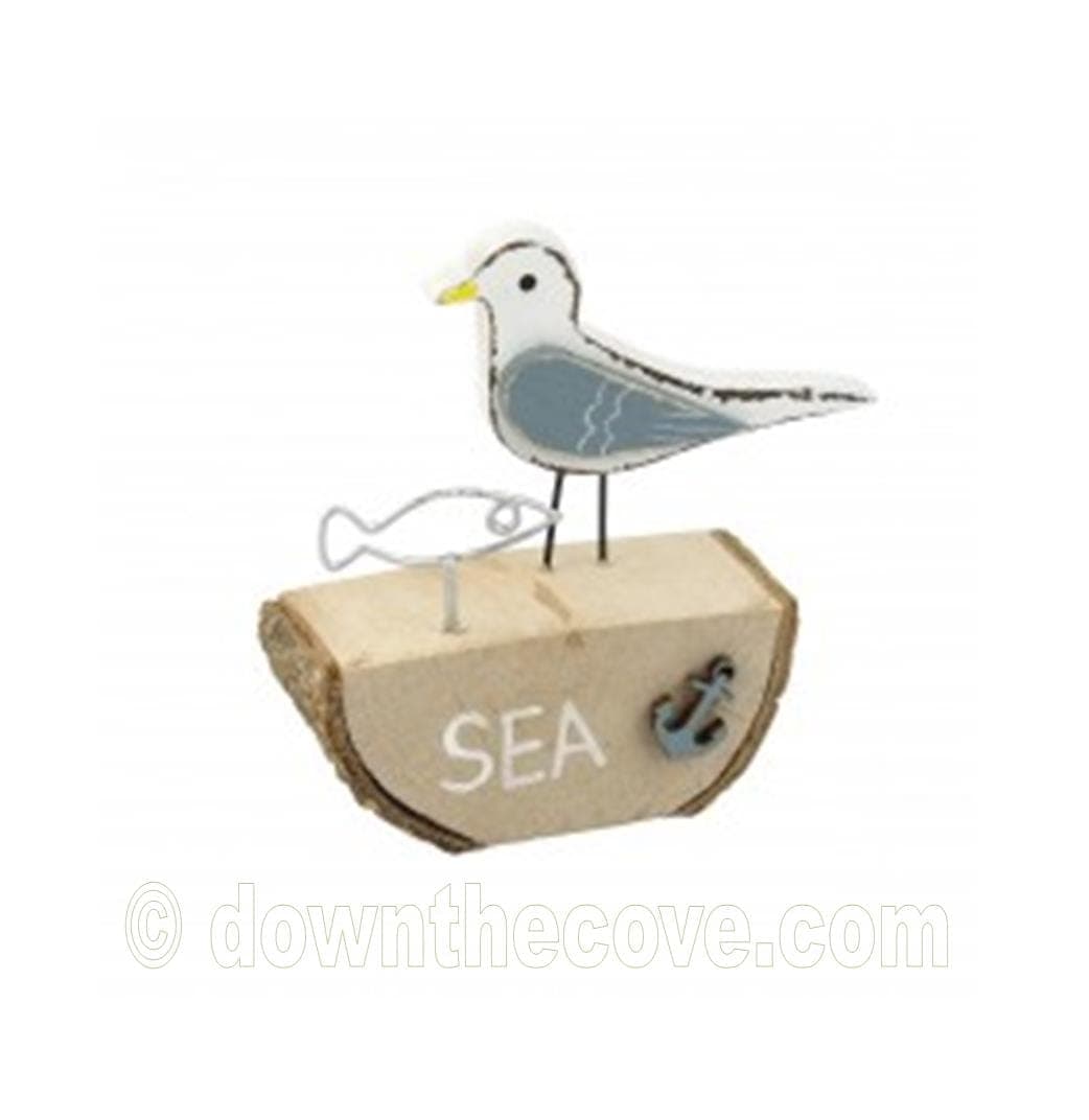 Wooden Seagull With Wire Fish Ornament On Log