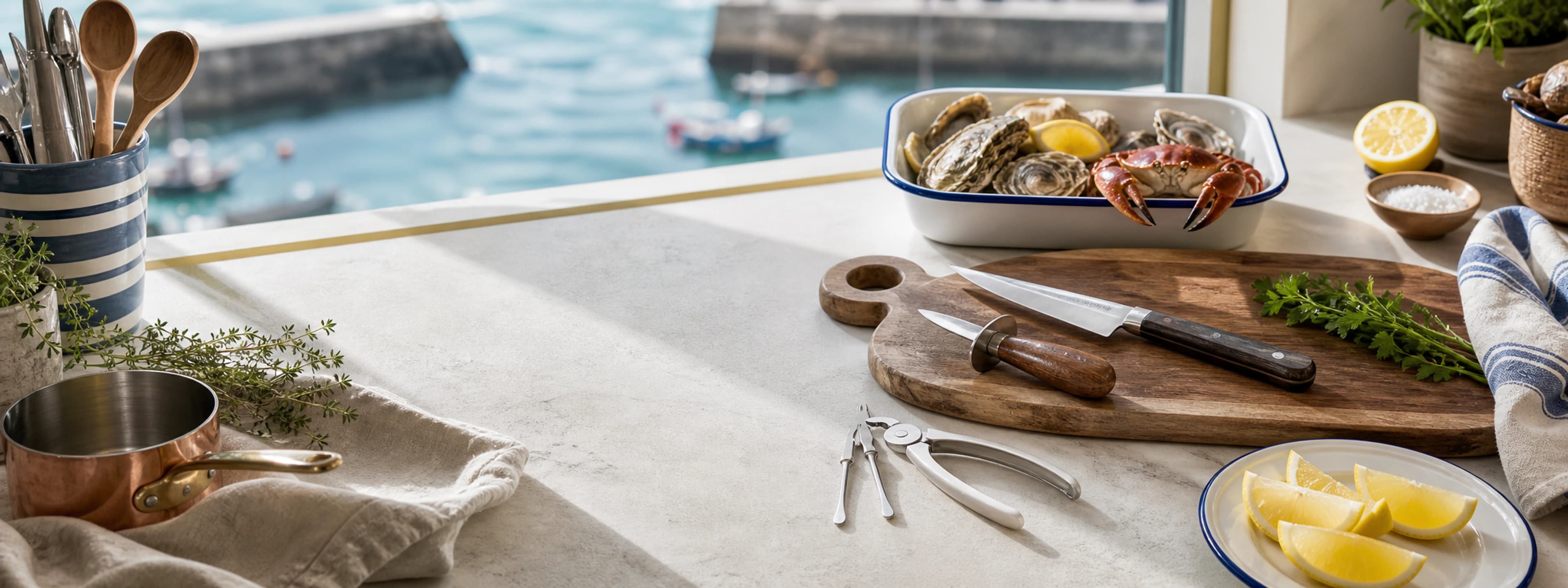 Seafood tools, knives, serving pieces, lemon and herbs arranged around a wooden serving board